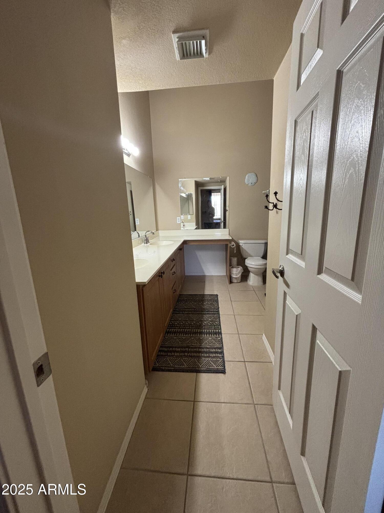 10136 East Southern Avenue, Unit 2048 Mesa, AZ 85209 - Photo 14 of 23 a bathroom with a sink a toilet and a mirror