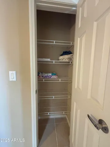 a view of a storage and utility room with racks on the wall
