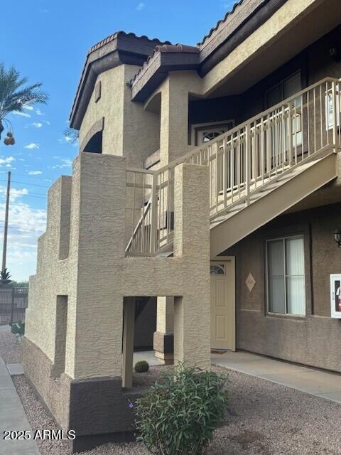 10136 East Southern Avenue, Unit 2048 Mesa, AZ 85209 - Photo 20 of 23 a front view of a house with balcony
