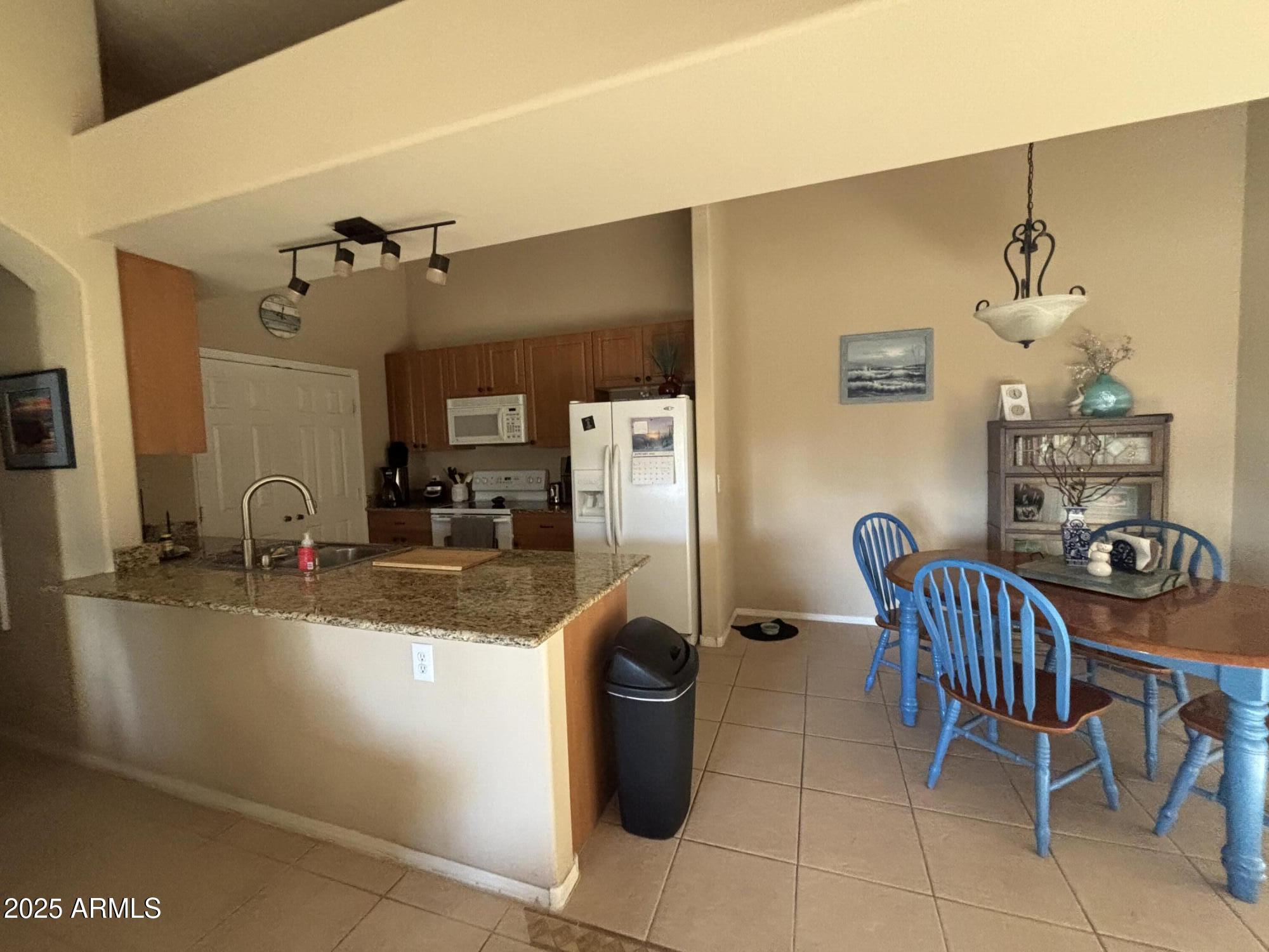 10136 East Southern Avenue, Unit 2048 Mesa, AZ 85209 - Photo 3 of 23 a dining room with furniture and a table