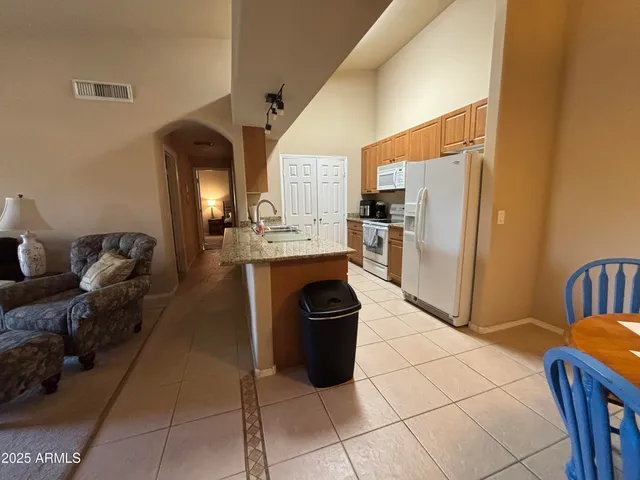 a living room with furniture a fireplace and a chandelier