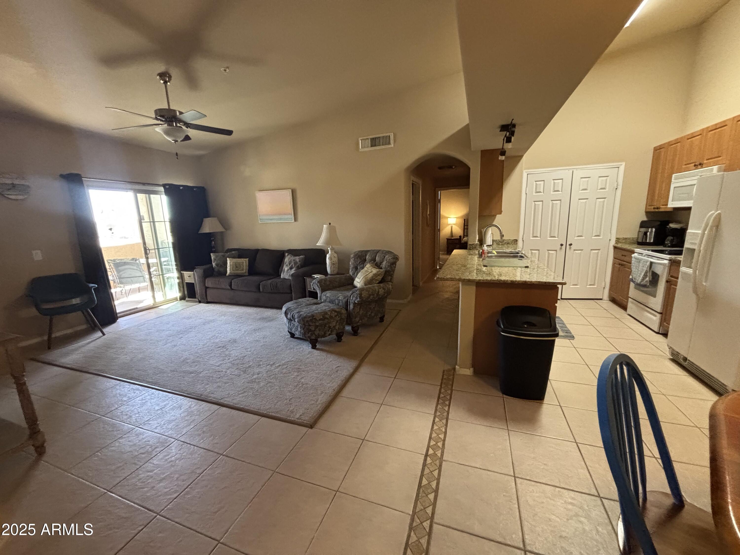 10136 East Southern Avenue, Unit 2048 Mesa, AZ 85209 - Photo 6 of 23 a living room with furniture a fireplace and a chandelier