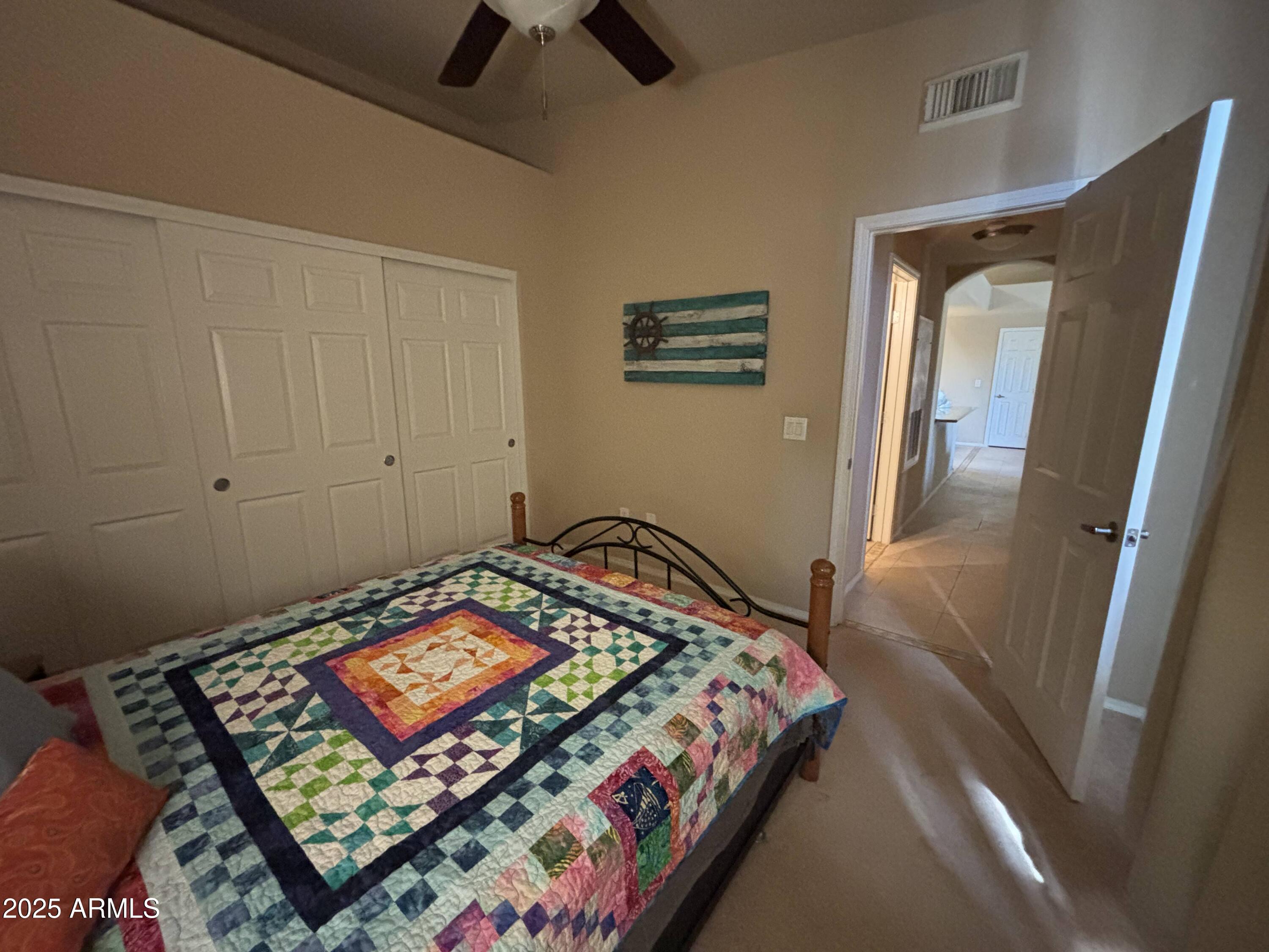 10136 East Southern Avenue, Unit 2048 Mesa, AZ 85209 - Photo 9 of 23 a bedroom with a bed and a lamp on dresser