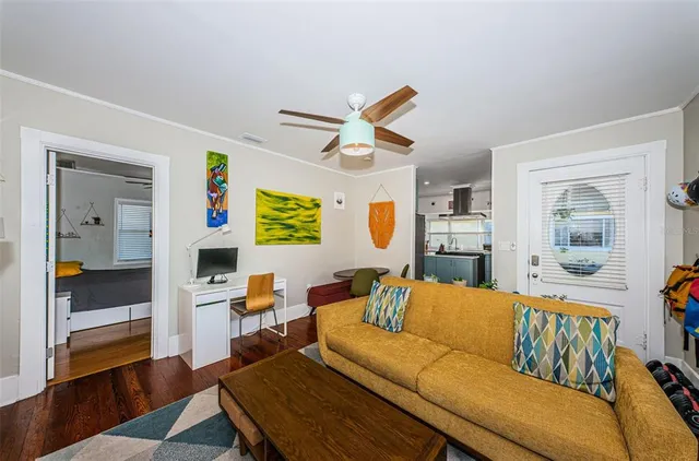 a living room with furniture and a wooden floor