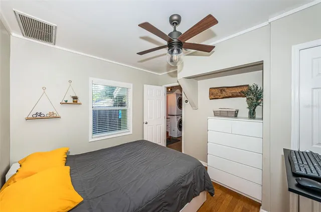 a bedroom with a bed and a painting on the wall