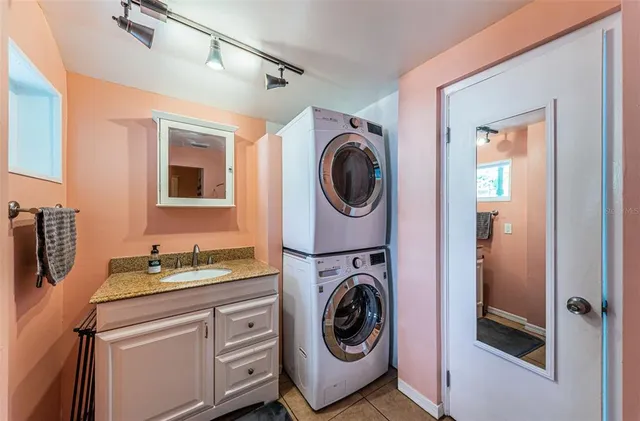 a utility room with sink dryer and washer