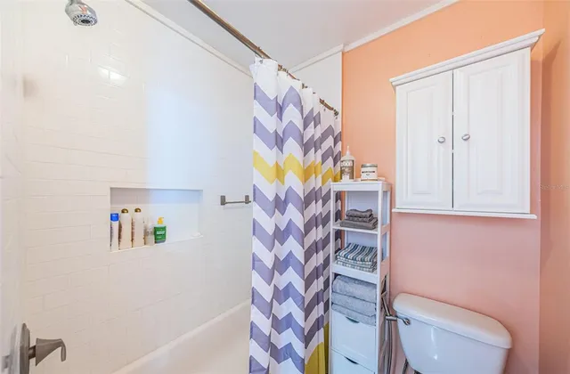 a bathroom with a bathtub and a shower curtain