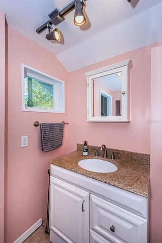 a bathroom with a sink a vanity and mirror