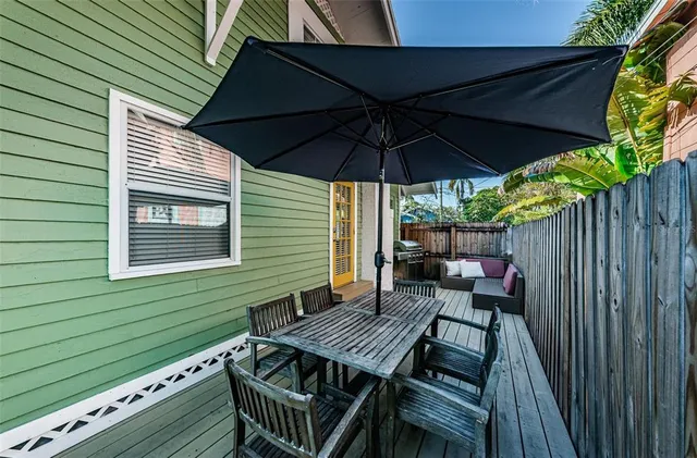 a view of outdoor sitting area with furniture and umbrella