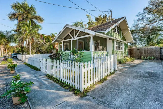 a front view of house with wooden fence