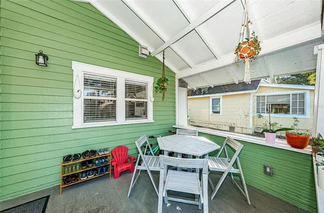 a backyard of a house with outdoor seating