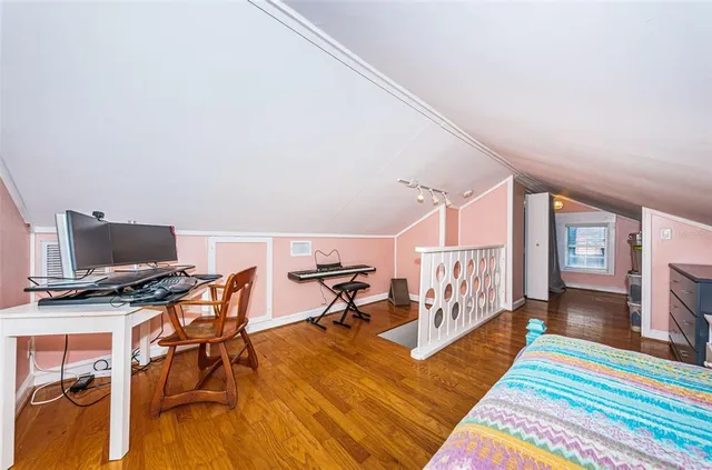 a bedroom with furniture and a wooden floor