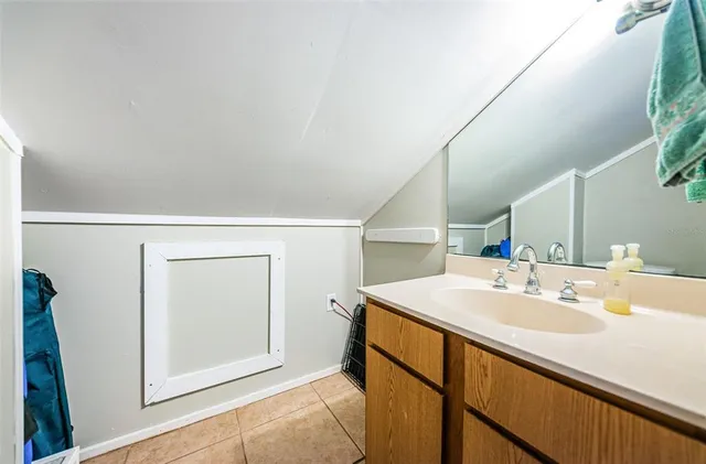 a bathroom with a sink vanity and mirror