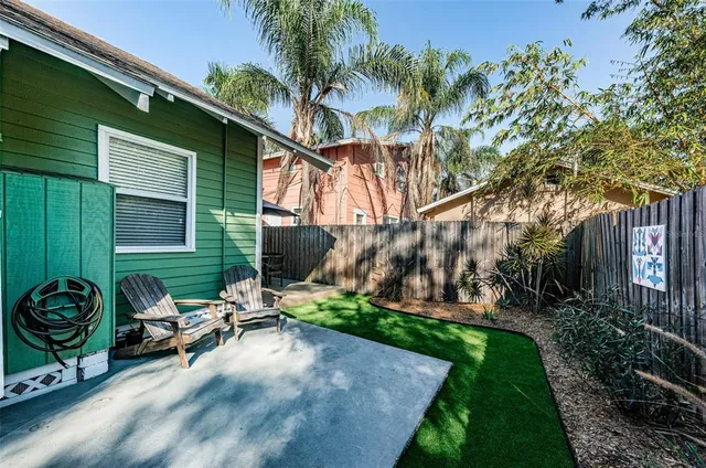 a view of a chairs and table in backyard