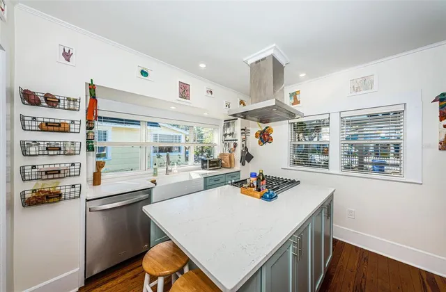 a kitchen with a sink a stove and a refrigerator
