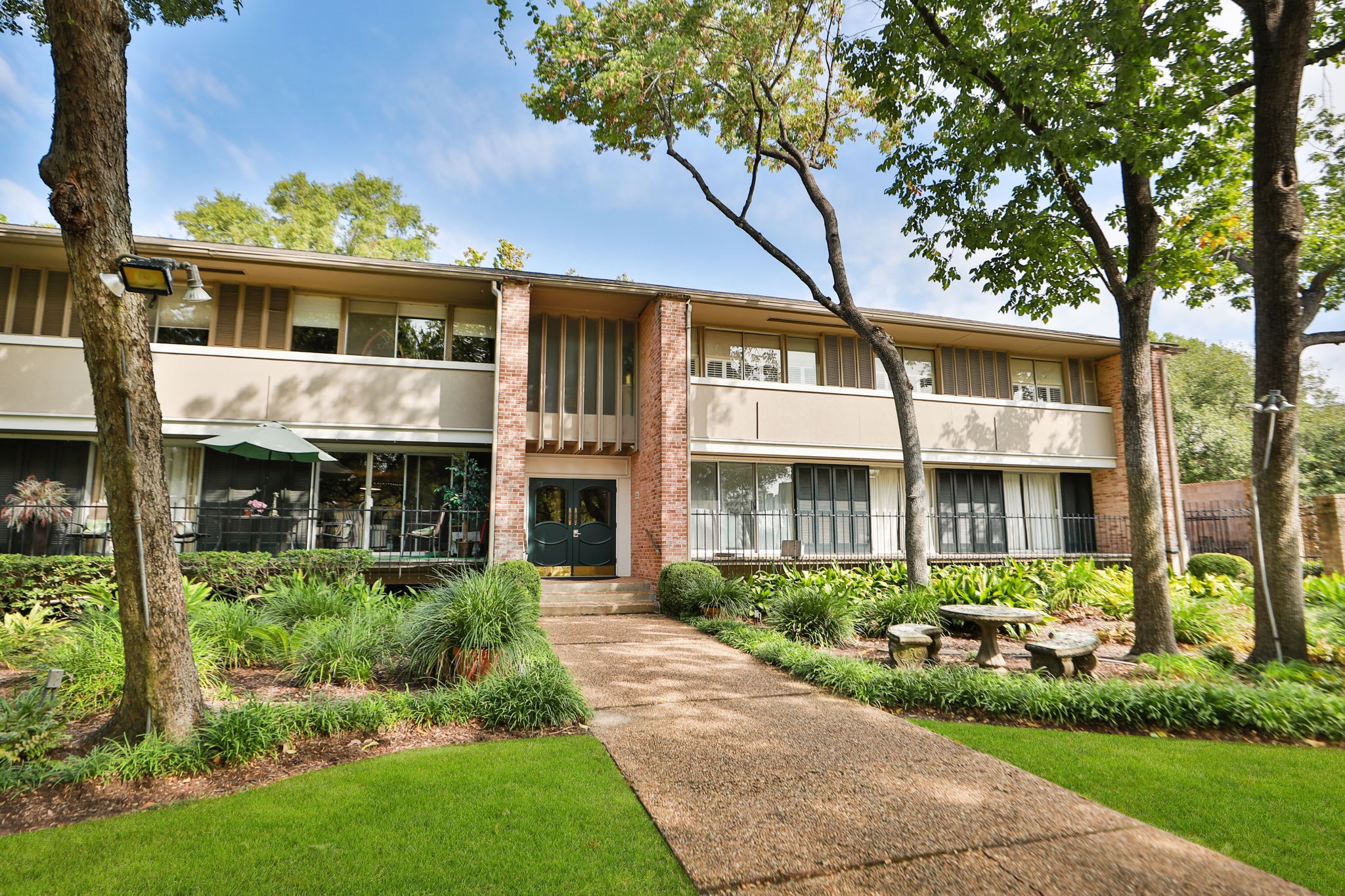 666 South Ripple Creek Drive, Unit 666 Houston, TX 77057 - Photo 1 of 49 a front view of a house with garden