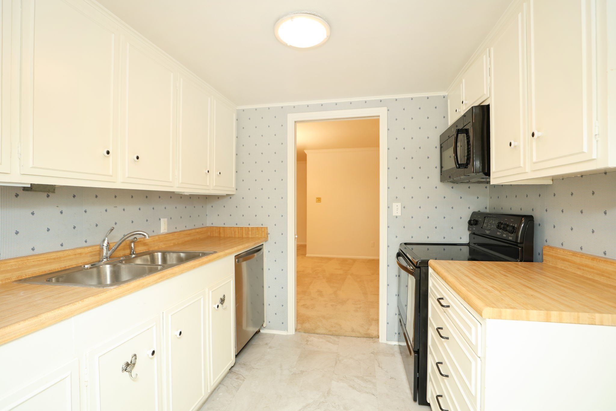 666 South Ripple Creek Drive, Unit 666 Houston, TX 77057 - Photo 11 of 49 a kitchen with stainless steel appliances granite countertop a sink a stove and a refrigerator