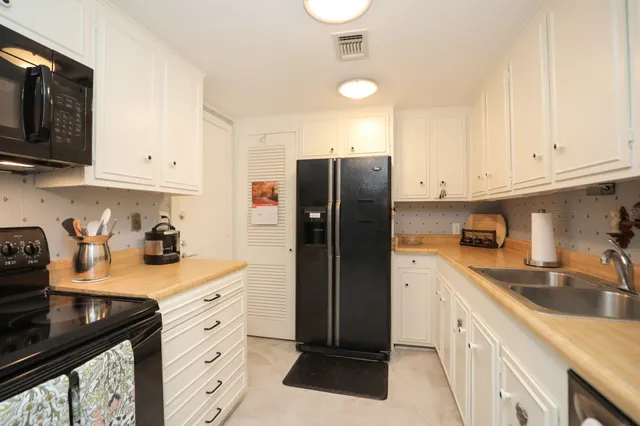 a bathroom with a double vanity sink a mirror and a shower