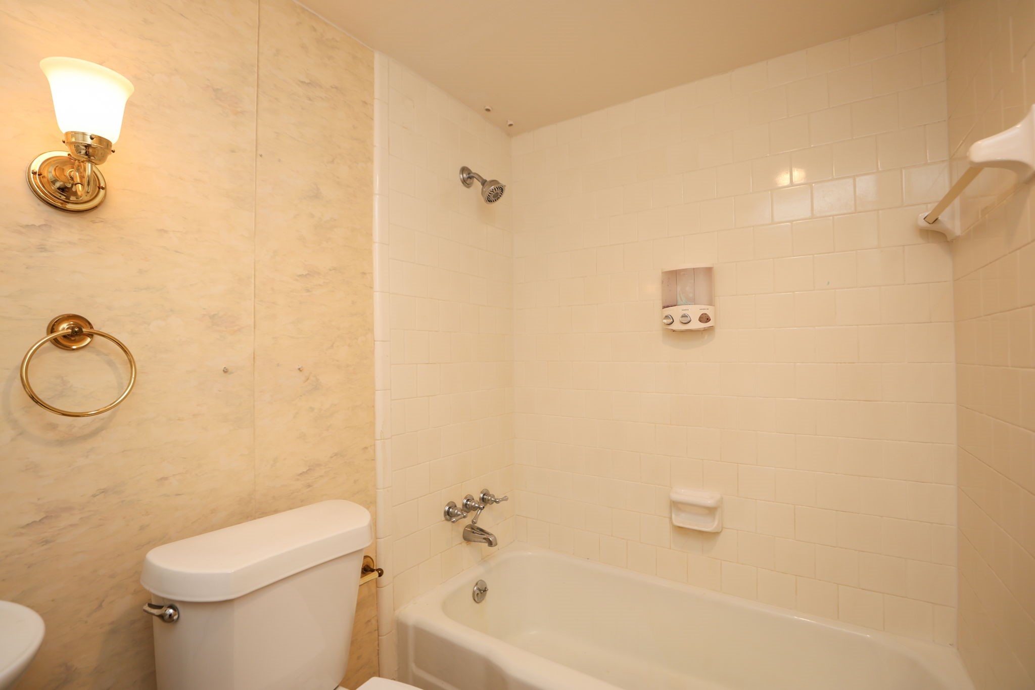 666 South Ripple Creek Drive, Unit 666 Houston, TX 77057 - Photo 19 of 49 a white toilet sitting next to a bath tub