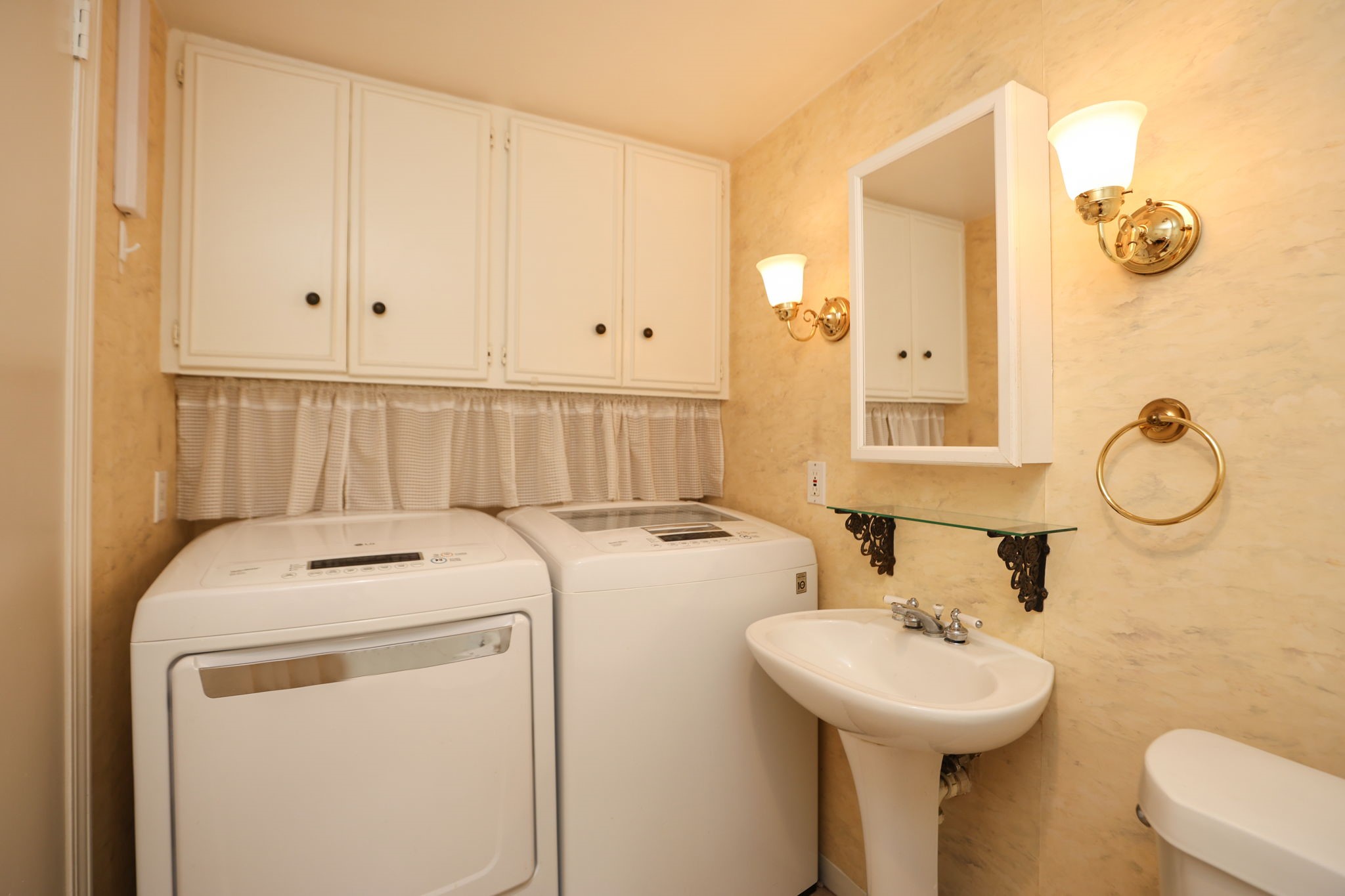666 South Ripple Creek Drive, Unit 666 Houston, TX 77057 - Photo 20 of 49 a bathroom with a sink a toilet and mirror