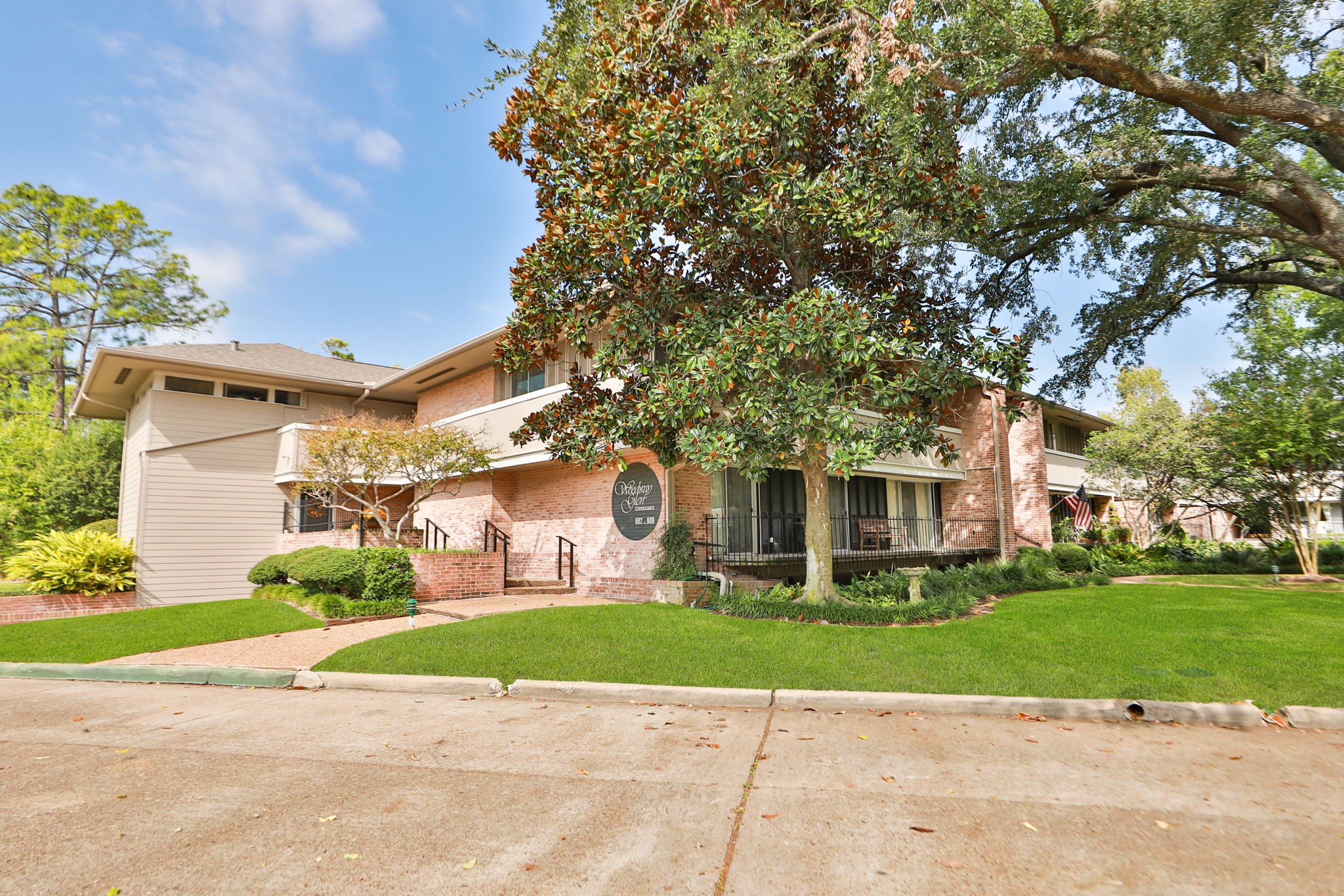 666 South Ripple Creek Drive, Unit 666 Houston, TX 77057 - Photo 34 of 49 a front view of a house with a garden and trees