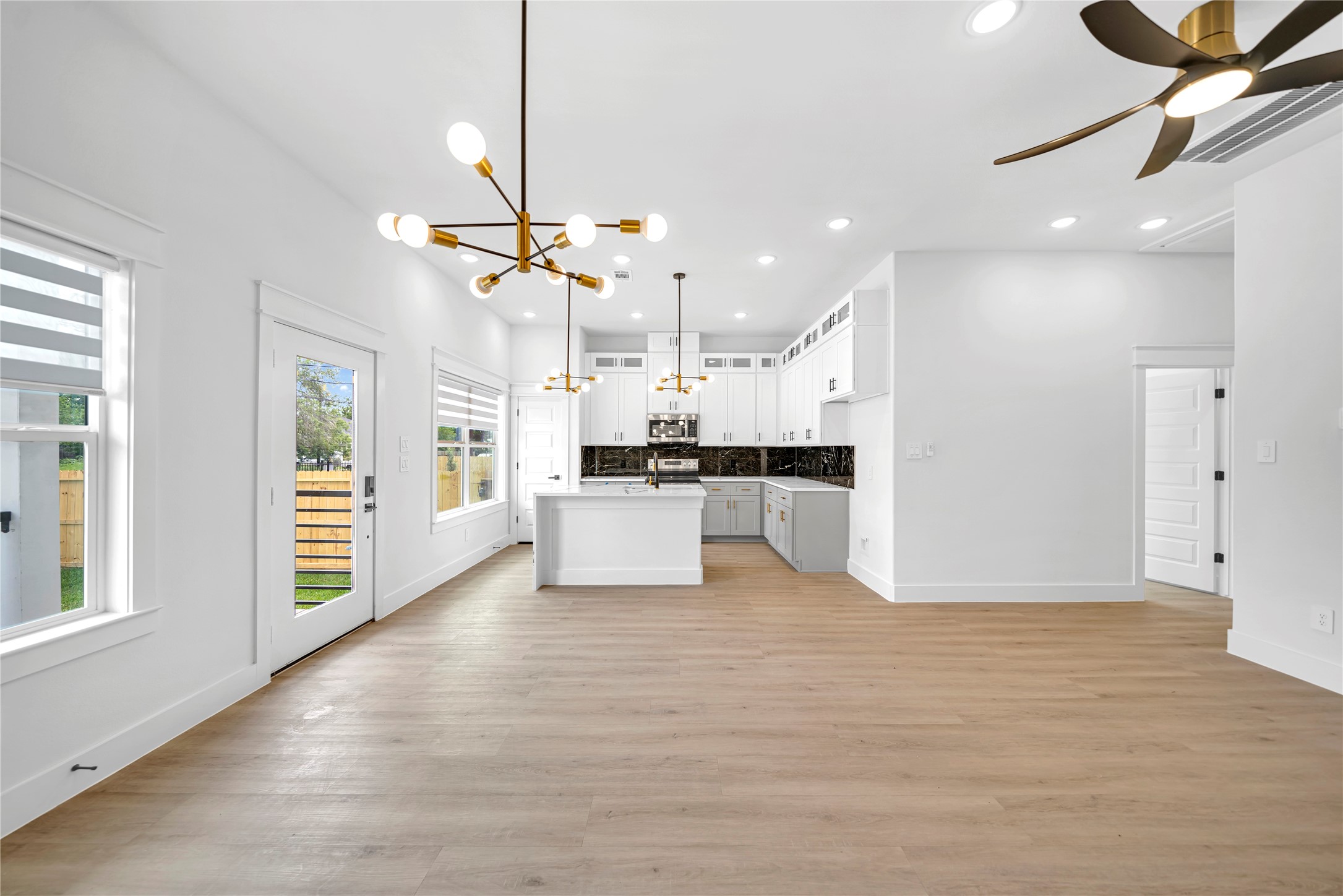4834 Higgins Street, Unit B Houston, TX 77033 - Photo 5 of 34 a view of a kitchen with refrigerator and wooden floor