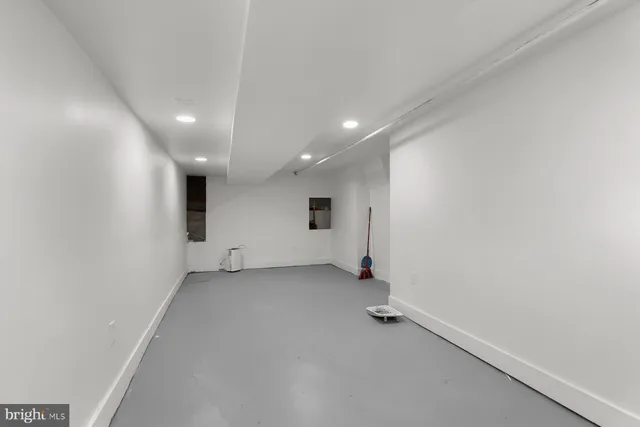 an empty room with a empty space and windows