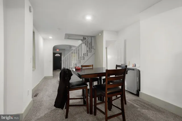 a dining room with furniture and window