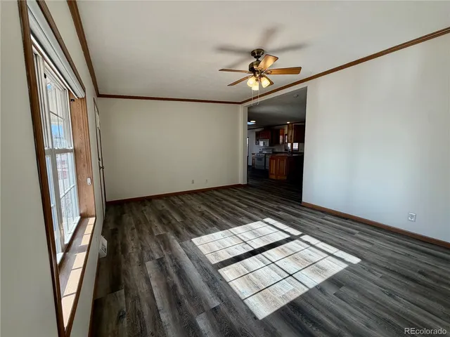 a view of an empty room and wooden floor