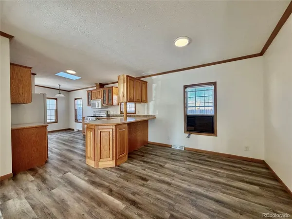 a view of kitchen with cabinets and wooden floor