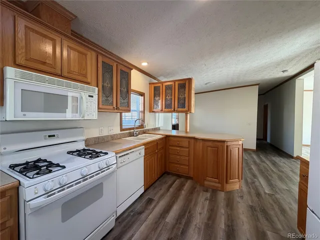 a kitchen with stainless steel appliances granite countertop a stove and a sink
