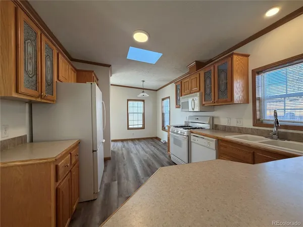 a kitchen with stainless steel appliances granite countertop a sink stove and cabinets