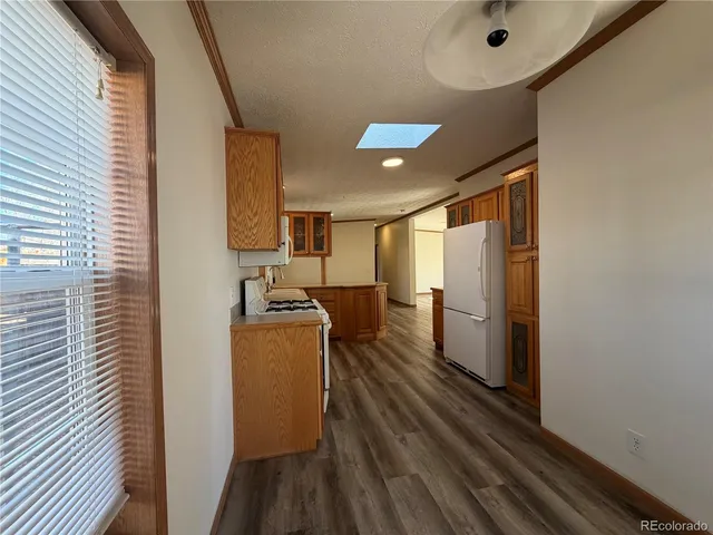 a kitchen with stainless steel appliances granite countertop a refrigerator and a stove top oven