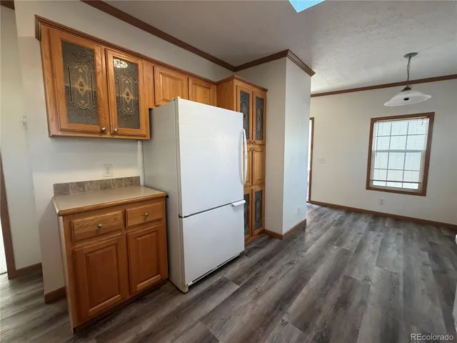 a white refrigerator freezer and a stove sitting inside of a kitchen