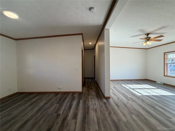 a view of empty room with wooden floor
