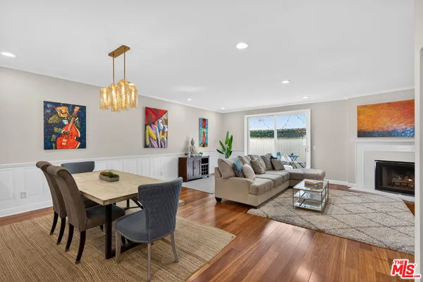 a living room with furniture dining table and a fireplace