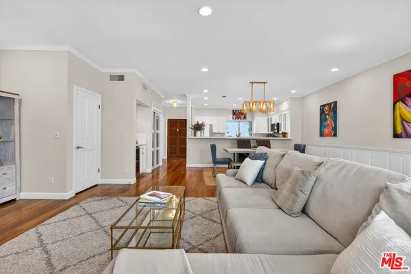a living room with furniture and kitchen view