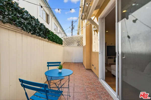 a backyard of a house with table and chairs