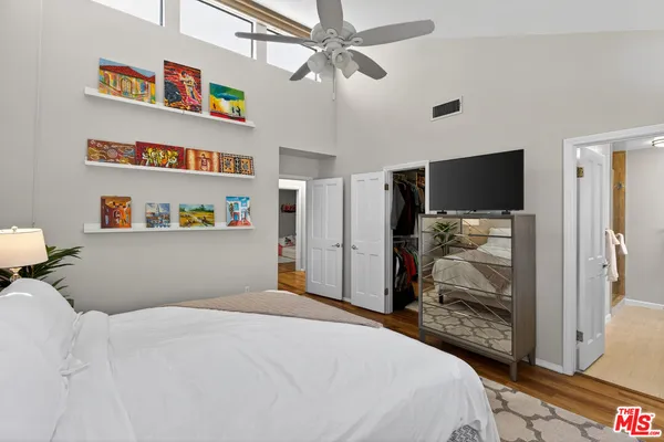 a bedroom with bed and a large mirror