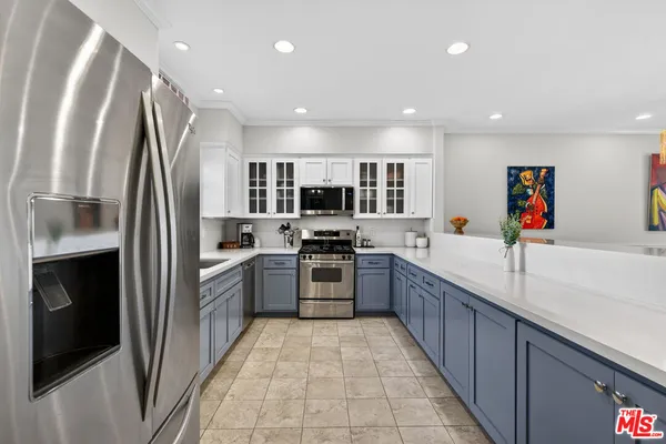 a kitchen with stainless steel appliances granite countertop a refrigerator and a sink