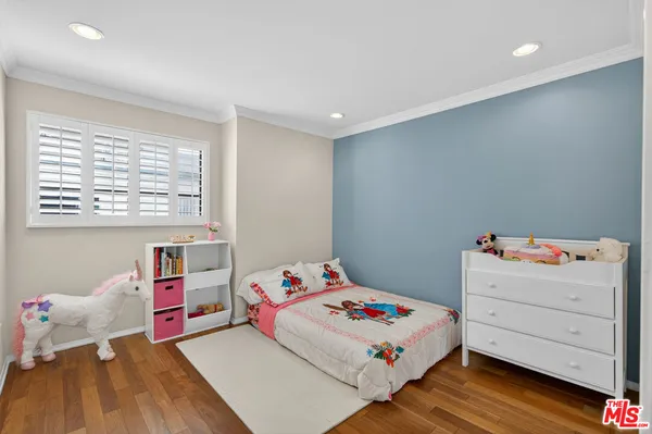 a bedroom with a bed and a dresser in it