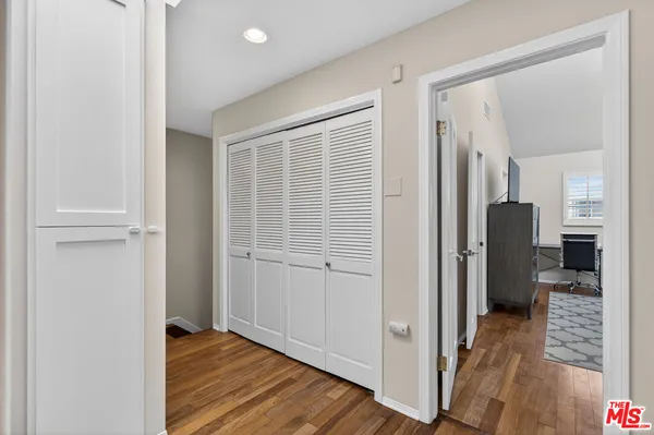 a view of hallway with wooden floor