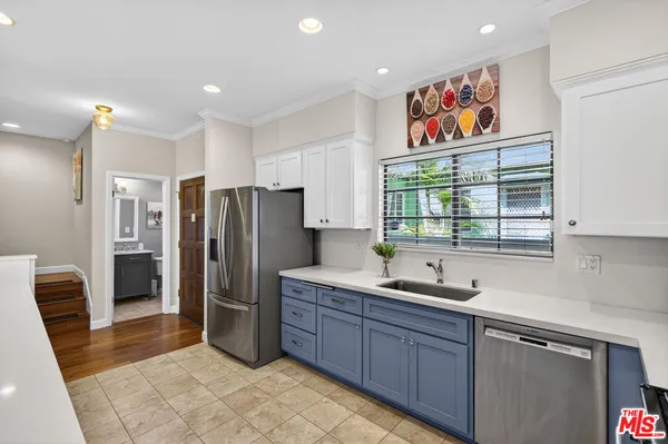a kitchen with stainless steel appliances granite countertop a refrigerator and a sink