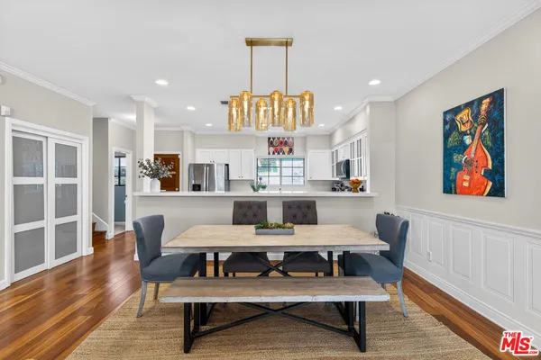 a living room with furniture a rug and kitchen view