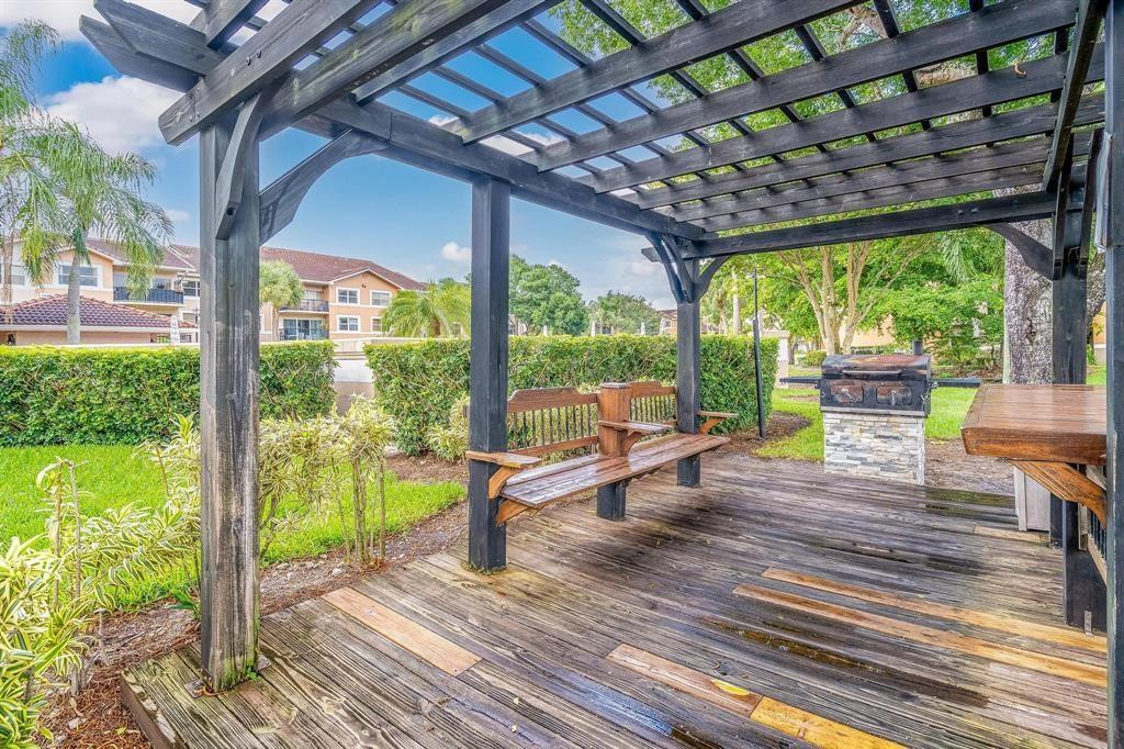 8851 Wiles Road, Unit 305 Coral Springs, FL 33067 - Photo 14 of 17 a house view with a sitting space and garden view