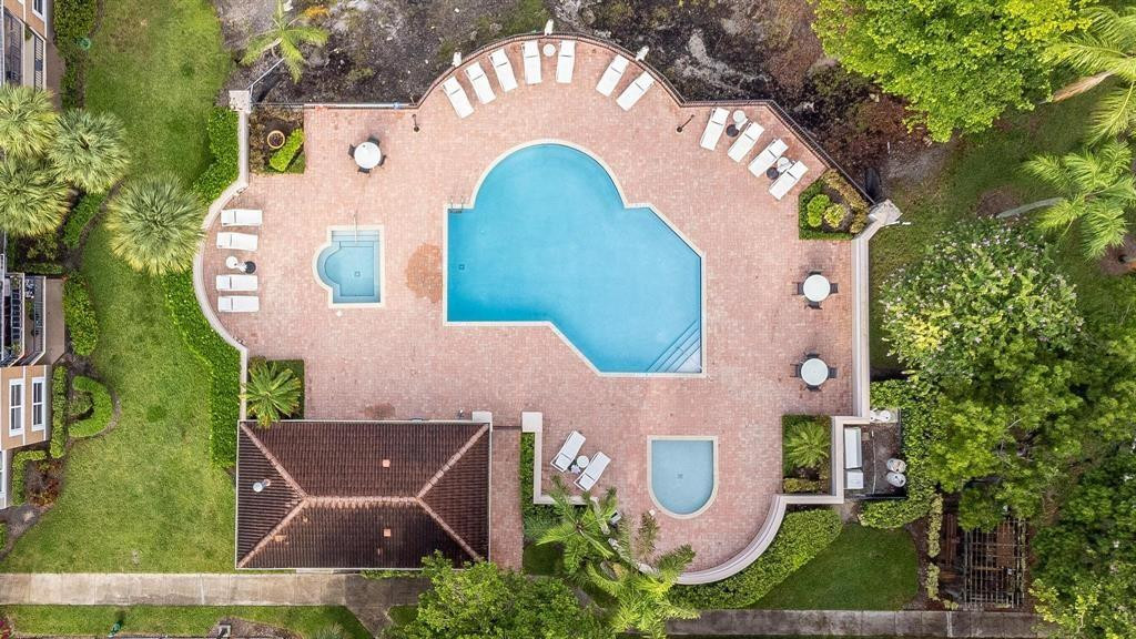 8851 Wiles Road, Unit 305 Coral Springs, FL 33067 - Photo 15 of 17 an aerial view of a house with garden space and swimming pool