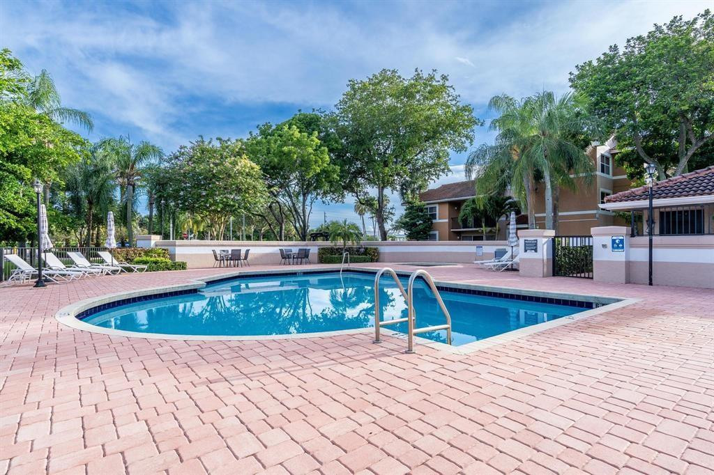 8851 Wiles Road, Unit 305 Coral Springs, FL 33067 - Photo 17 of 17 a view of outdoor space pool patio and yard