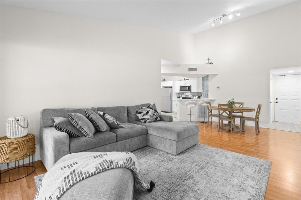 8851 Wiles Road, Unit 305 Coral Springs, FL 33067 - Photo 5 of 17 a living room with furniture and a view of kitchen