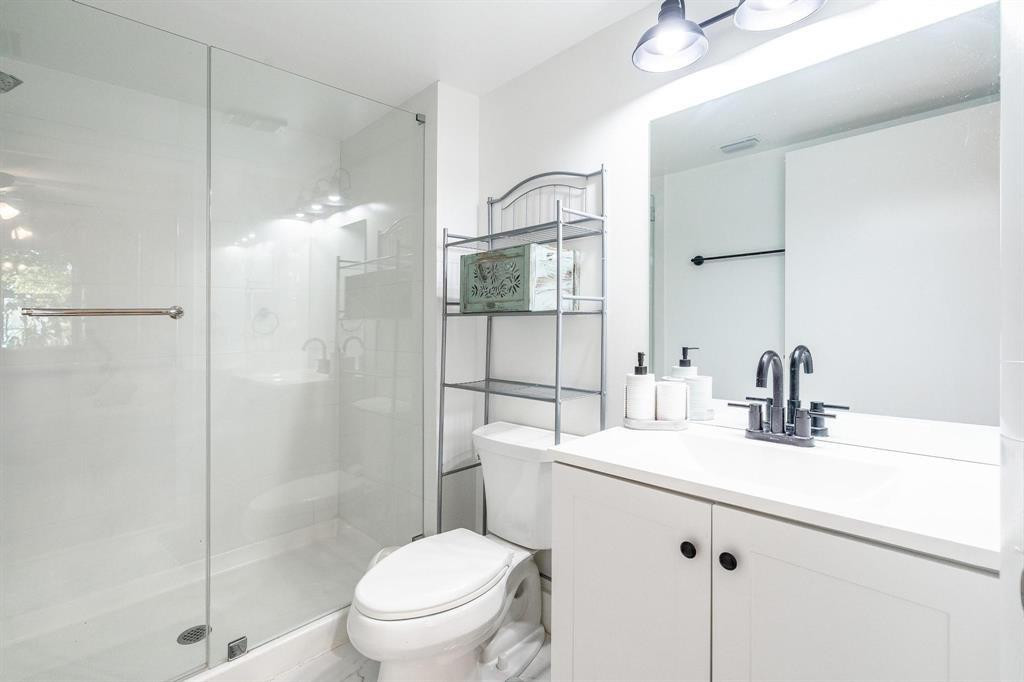 8851 Wiles Road, Unit 305 Coral Springs, FL 33067 - Photo 8 of 17 a bathroom with a sink toilet and shower