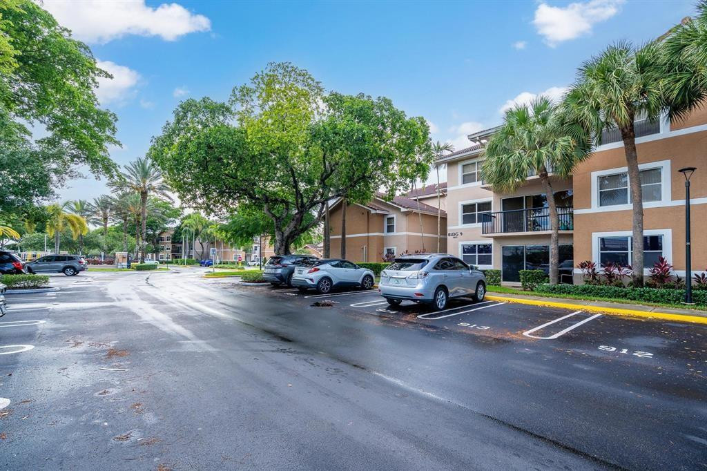 8851 Wiles Road, Unit 305 Coral Springs, FL 33067 - Photo 9 of 17 a view of a street with cars parked